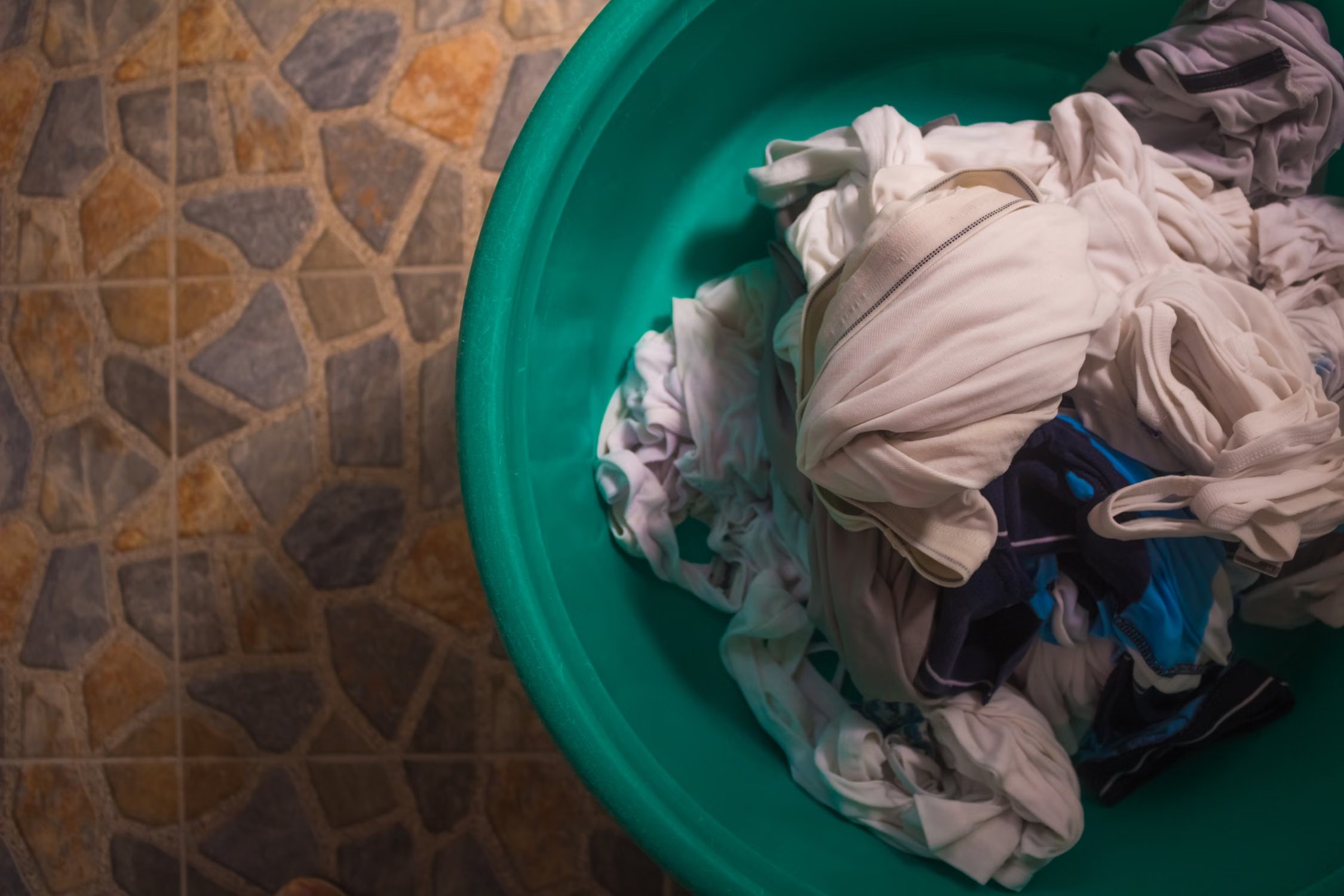 Overhead stock photo of a basket of everyday laundry before washing.