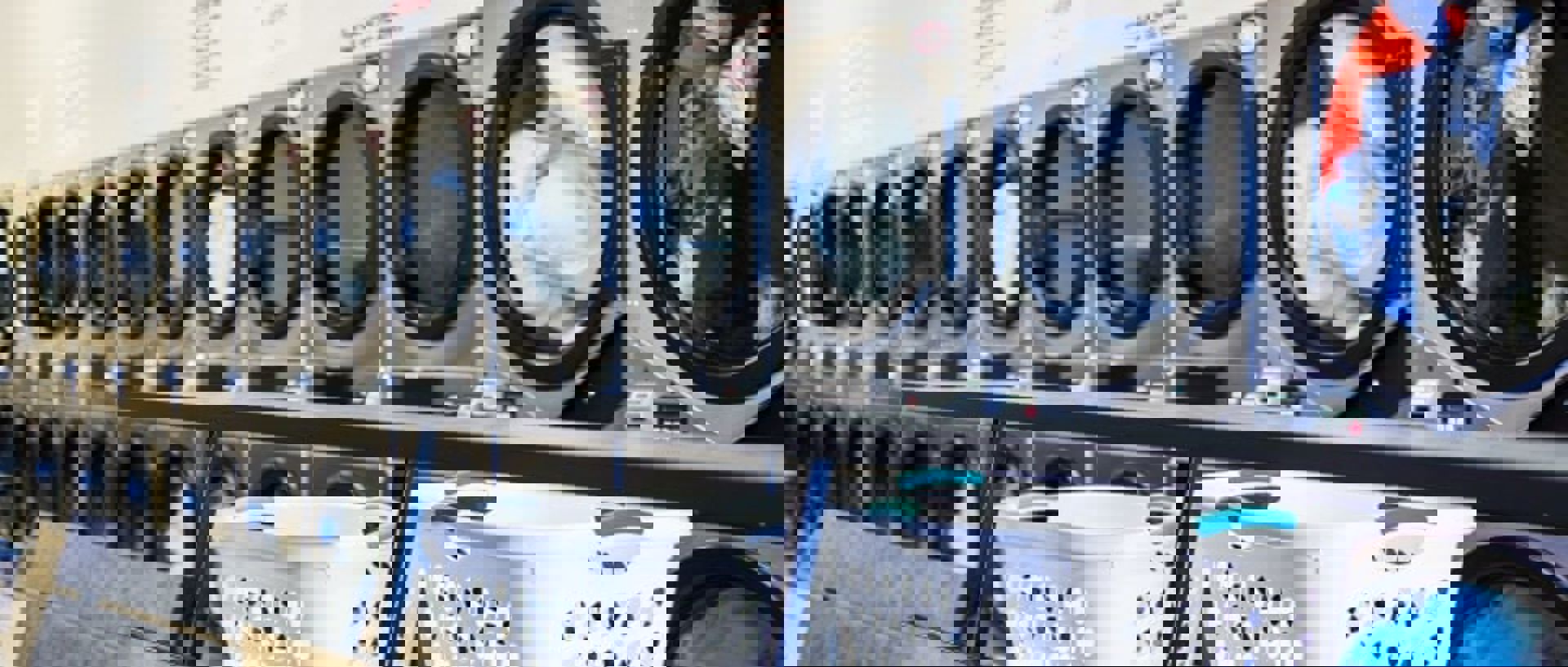 Row Of Washing Machines With Laundry Baskets Min 3